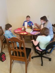 children sitting around kitchen table