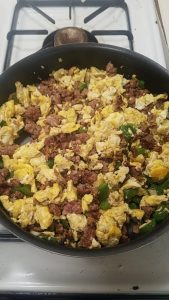 egg and veggie scramble in a pan